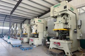 Progressive die stamping line running stainless steel strip at a metal stamping factory in Nanpi, Hebei, China